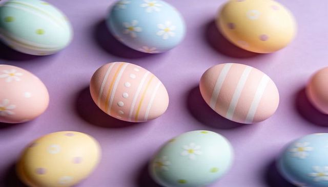 Displaying pastel hand-painted easter eggs on lavender background for spring celebrations