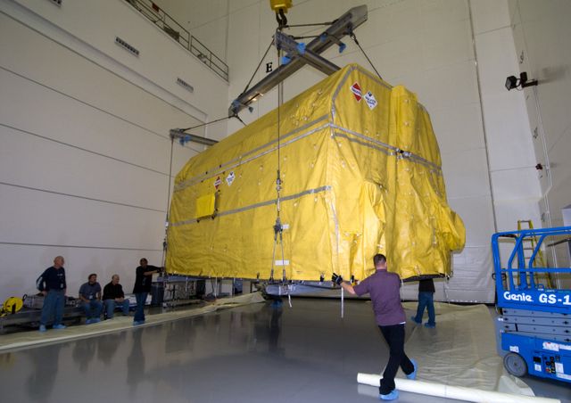 CAPE CANAVERAL, Fla. – At the Astrotech Space Operations facility in Titusville, Fla., workers lift NASA's GOES-P meteorological satellite from the transporter which delivered it from NASA Kennedy Space Center's Shuttle Landing Facility.    GOES-P, the latest Geostationary Operational Environmental Satellite, was developed by NASA for the National Oceanic and Atmospheric Administration, or NOAA.  GOES-P is designed to watch for storm development and observed current weather conditions on Earth.  Launch of GOES-P is targeted for no earlier than Feb. 25, 2010, from Launch Complex 37 aboard a United Launch Alliance Delta IV rocket.  For information on GOES-P, visit http://goespoes.gsfc.nasa.gov/goes/spacecraft/n_p_spacecraft.html. Photo credit: NASA/Amanda Diller