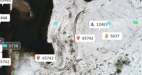 Aerial snowy shoreline revealing s-curve tire tracks with social media notification overlays
