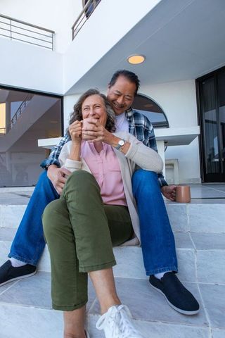 Senior Couple Relaxing on Modern White Outdoor Steps