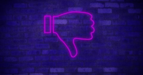 Neon pink thumbs down symbol against dark brick wall