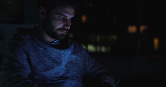 Man Working on Laptop At Night in Dimly Lit Room - Download Free Stock Images Pikwizard.com