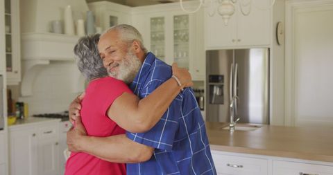 Senior couple embracing in modern kitchen setting