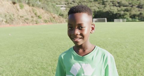 Cheerful Boy in Green T-Shirt Enjoying Sunny Day Outdoors
