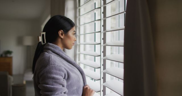 Image of biracial woman in rope looking outside window - Download Free Stock Photos Pikwizard.com