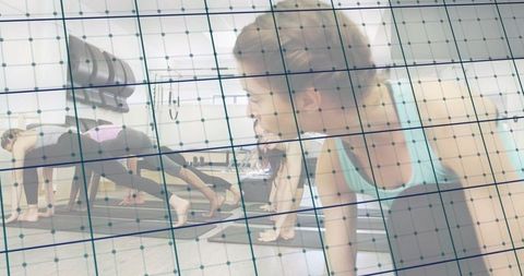 Woman holding plank in group fitness class with digital grid overlay and studio equipment