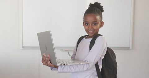 Child Student with Laptop in Classroom Learning Environment