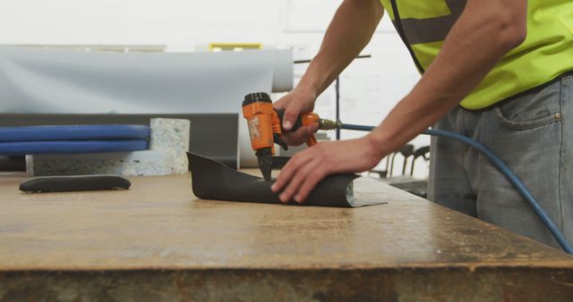 Worker uses a drill on a workshop table, with copy space - Download Free Stock Photos Pikwizard.com