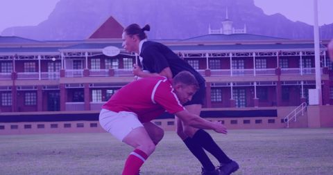 Intense Rugby Match at School Campus Amid Mountain Backdrop