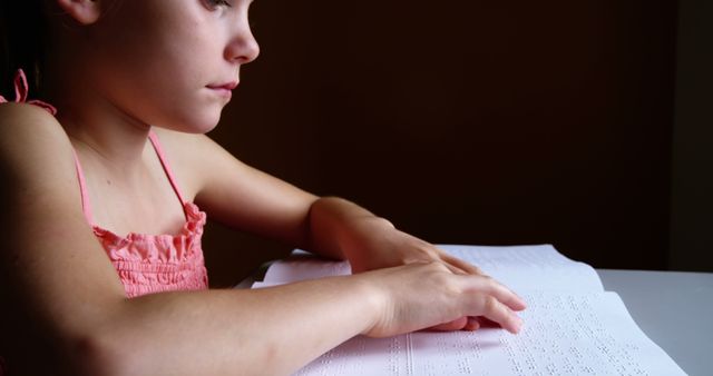 Visually Impaired Girl Reading Braille Book with Focused Expression - Download Free Stock Images Pikwizard.com