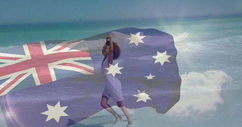 Joyful Woman Holding Australian Flag on Sandy Beach