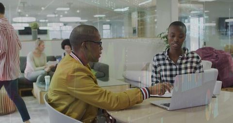 Coworker Collaboration in Modern Lounge with Laptop