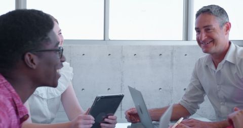 Colleagues Engaging in Lively Team Meeting in Office