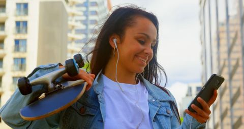 Young Woman Enjoying City Life with Smartphone and Skateboard - Download Free Stock Images Pikwizard.com