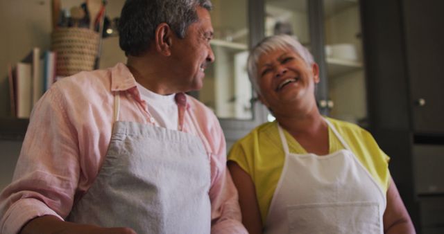 Laughing Senior Couple Enjoying Time in Kitchen - Download Free Stock Images Pikwizard.com