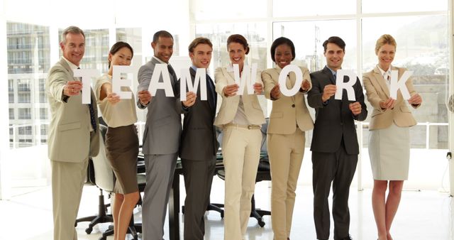 Diverse Business Team Holding Teamwork Letters in Modern Office - Download Free Stock Images Pikwizard.com