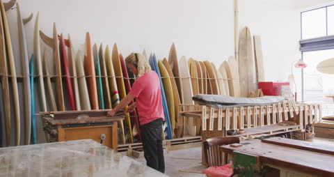 Surfboard Craftsman Creating Custom Boards in Wood Workshop