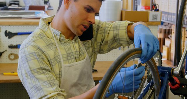 Man repairing bicycle wheel in workshop - Download Free Stock Images Pikwizard.com