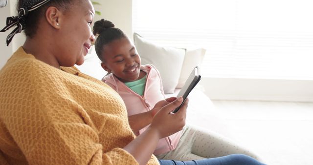 Mother and Daughter Bonding While Using Tablet at Home - Download Free Stock Images Pikwizard.com