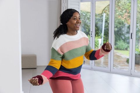 African american woman exercising in bright minimalist living room