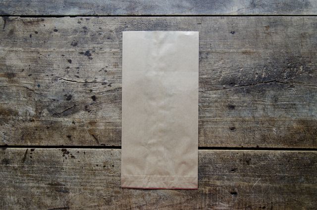 Empty Brown Paper Bag on Wooden Surface Top View - Download Free Stock Photos Pikwizard.com
