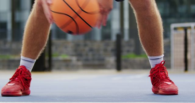 Close-Up of Player Dribbling Basketball in Red Shoes on Outdoor Court - Download Free Stock Images Pikwizard.com