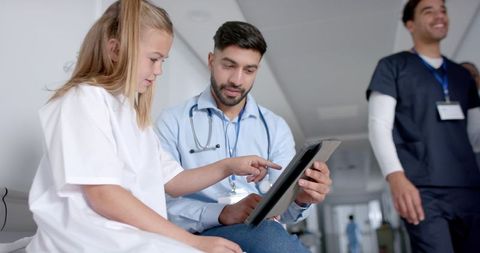 Doctor and Child Engaging in Medical Consultation Using Tablet - Download Free Stock Images Pikwizard.com