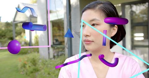 Woman gazing through glass with neon 3d geometric overlay in modern garden pavilion