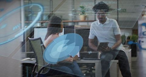 Collaborating on code with holographic UI in open-plan workspace, tablet and dual monitors