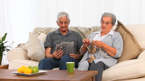 Elderly Couple Relaxing with Hobbies at Home