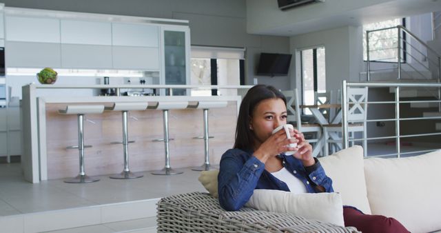 Relaxed Woman Drinking Coffee in Modern Living Room - Download Free Stock Images Pikwizard.com