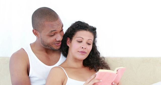 Interracial couple reading a book together - Download Free Stock Images Pikwizard.com