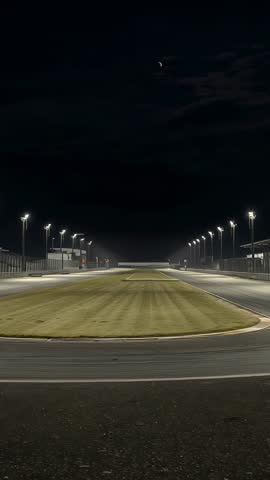 Recording vertical video capturing illuminated motorsport track under floodlights at night