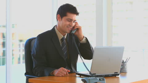 Businessman Conducting Phone Call in Modern Office