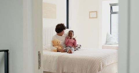 Loving Mother and Child in Cozy Bedroom Setting