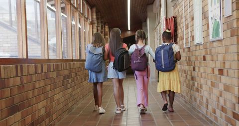 Diverse Group of Girls with Backpacks Exploring School Corridor - Download Free Stock Images Pikwizard.com