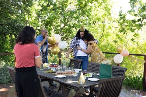 Diverse friends enjoy outdoor celebration with balloons