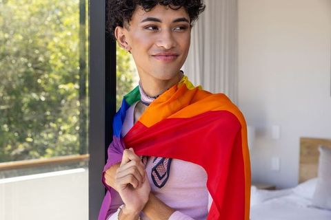 Young man embracing diversity with rainbow pride flag