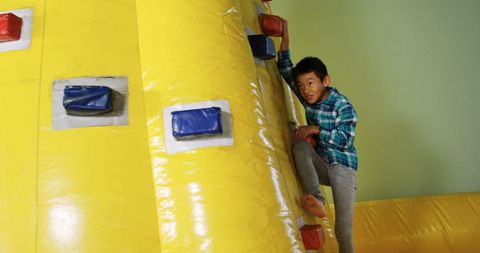 Asian Boy Climbing Indoor Wall Adventure Spirit - Download Free Stock Images Pikwizard.com