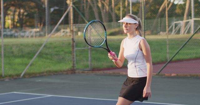 Young Woman Playing Tennis on Outdoor Court at Sunset - Download Free Stock Images Pikwizard.com