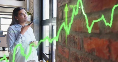 Female Business Professional Engaging with Holographic Data in Office