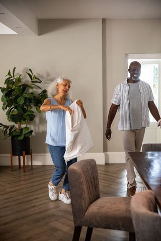 Smiling Mature Couple in Modern Home with White Shirt