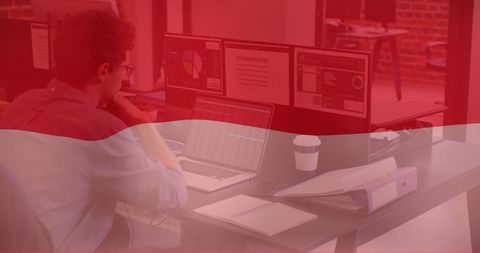 Businessman Working With Indonesian Flag Overlay in Office
