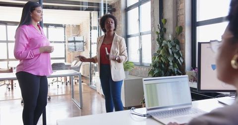 Diverse Women's Team Collaborating in Modern Office Environment