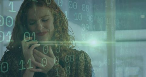 Businesswoman communicates with smartphone and binary overlay