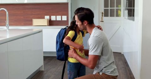 Father Bidding Farewell to Daughter in Modern Kitchen