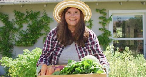 Smiling Woman Harvesting Fresh Vegetables in Lush Garden - Download Free Stock Images Pikwizard.com