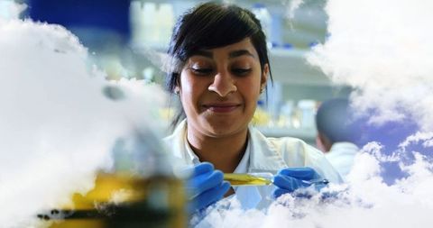 Scientist conducting experiment in laboratory with pipette action