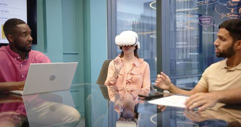 Colleagues Discussing VR Technology in Modern Office