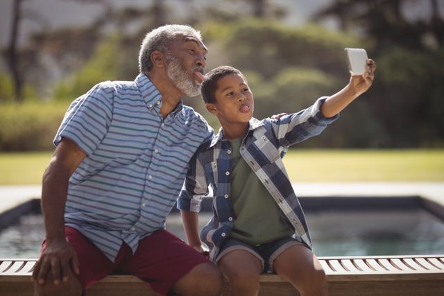 Grandfather and Grandson Taking Selfie by Poolside - Download Free Stock Photos Pikwizard.com